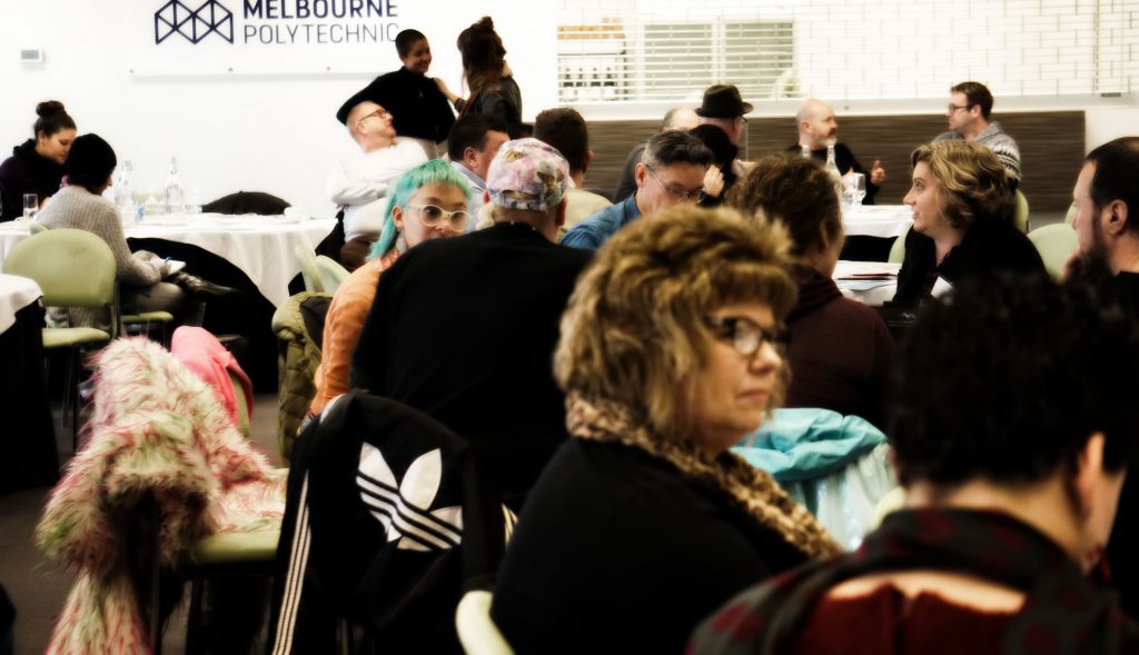 picture of people sitting and talking to each other at a forum